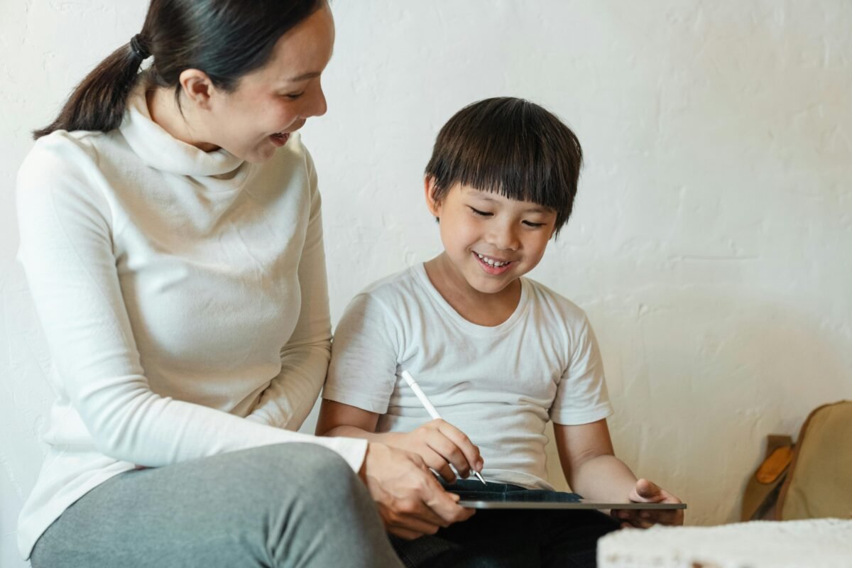 A parent guides their child during an educational activity on a tablet, illustrating effective digital parenting in a South African homeschool setting