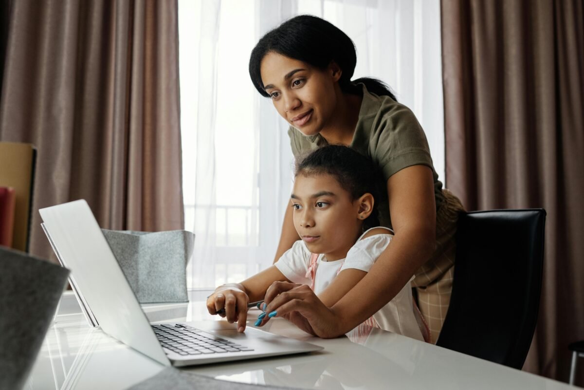 A mother and her child happily engaged in learning at home, demonstrating the positive parent and teacher role in homeschooling
