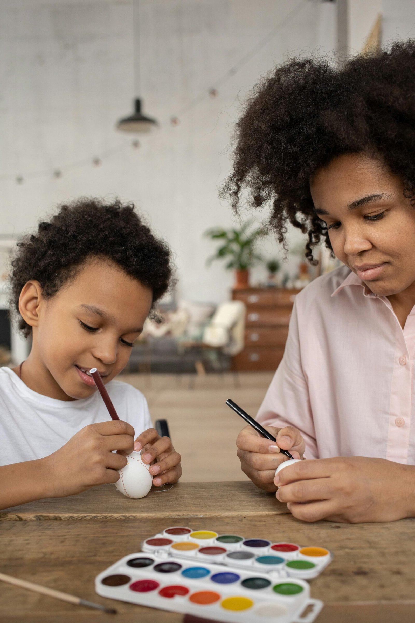 A colourful collection of supplies for Easter crafts for kids in South Africa, including paint, eggs, and brushes