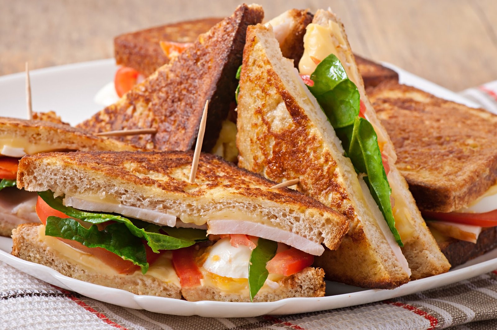 Delicious-French-toast-sandwich-with-cheese-tomato-and-ham