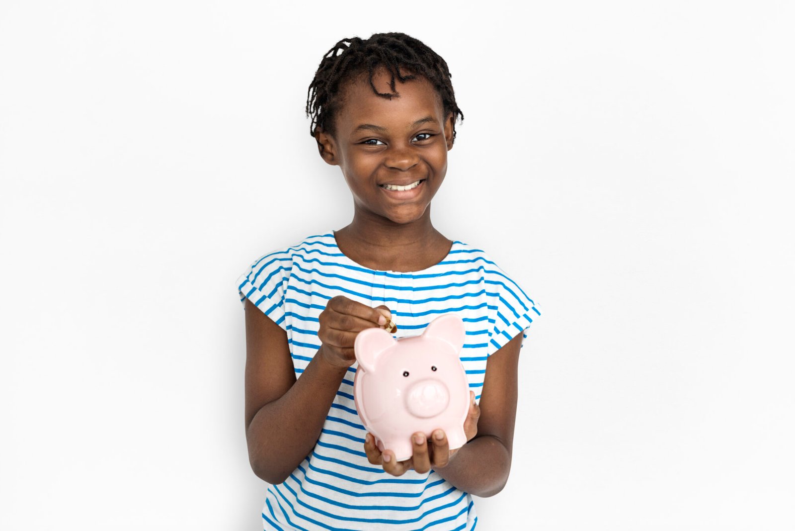 A-child-learning-about-teaching-kids-about-money-by-putting-a-coin-in-a-piggy-bank