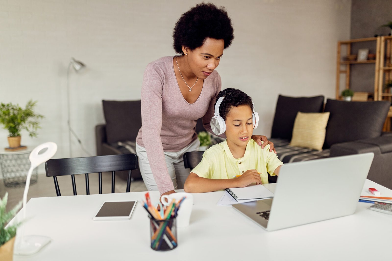 mother-assisting-her-son-homeschooling-curriculum-strategy